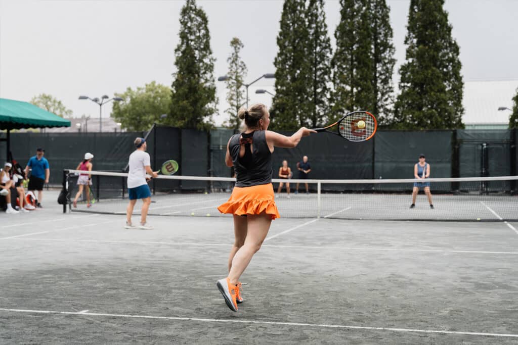 People playing a doubles tennis match