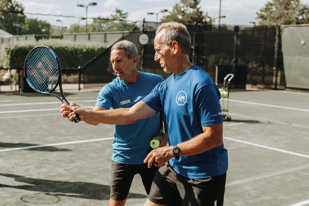 Tennis instructor teaching hitting drills