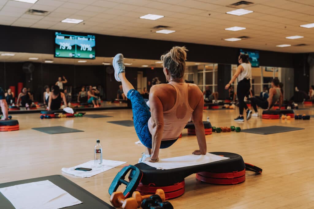 Woman participating in group exercise class