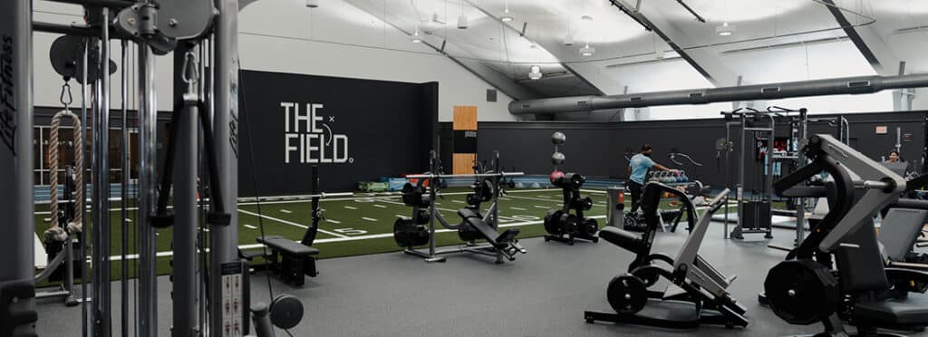 Fitness floor, consisting of turf field and strength equipment.