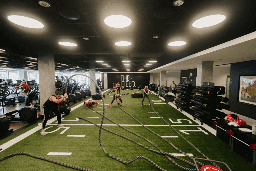 Members training with battle ropes on “The Field” turf at Midtown Athletic Club Weston — a premier fitness destination in Weston, FL offering functional training and state-of-the-art gym equipment.